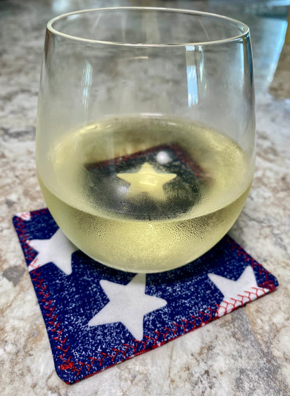 Clear glass with white liquid on a star-patterned coaster