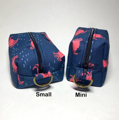 Size comparison of small and mini Island Life zipped keychain pouch.