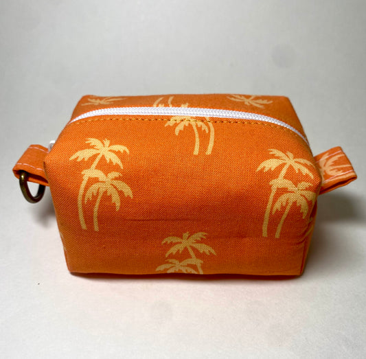 Orange pouch with gold palm tree pattern 